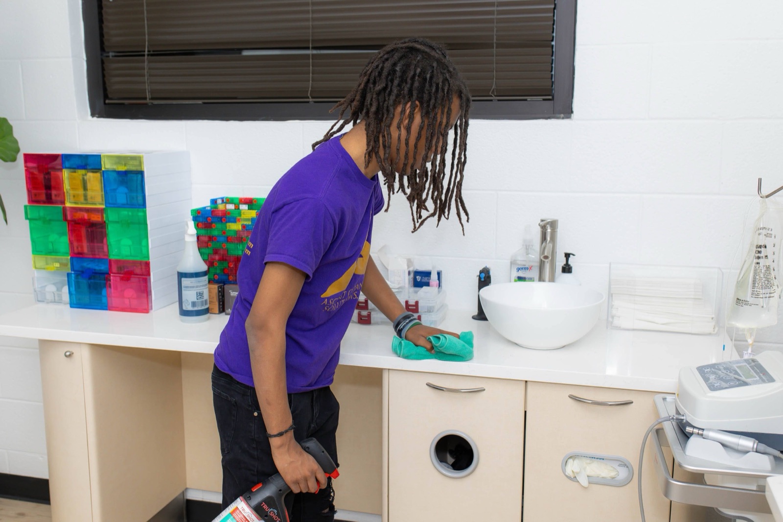 ACS team member wiping counter — Nashville office and facility cleaning detail