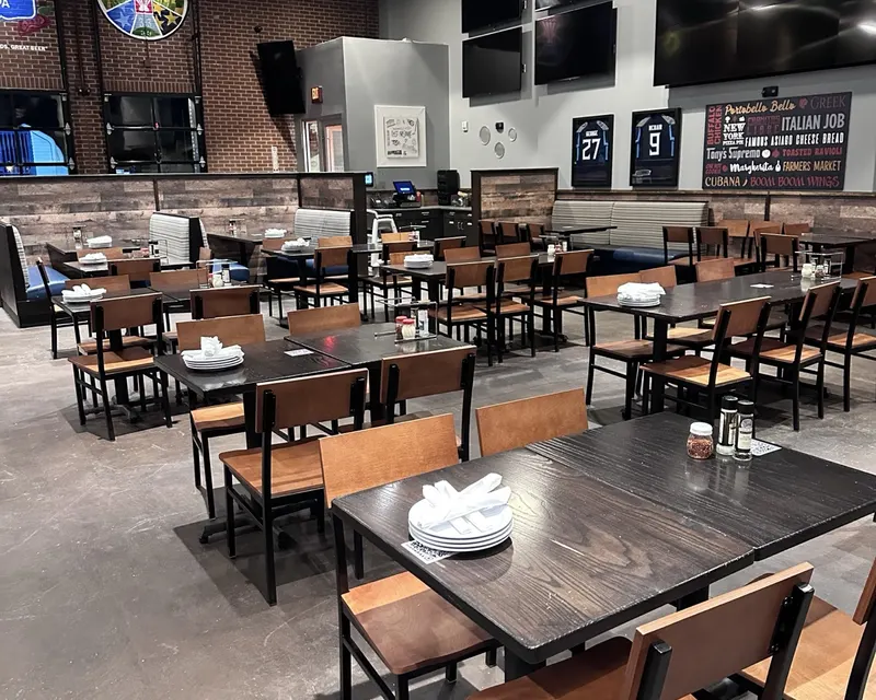 Nashville sports restaurant cleaned and set by Ascent Cleaning Solutions — empty tables, polished floor, ready for service