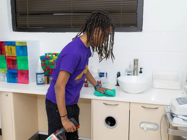 ACS team member wiping counter — Nashville office and facility cleaning detail